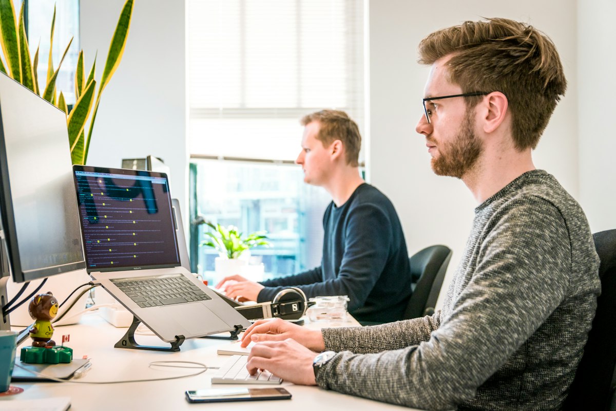Software professionals collaborating at their workstations